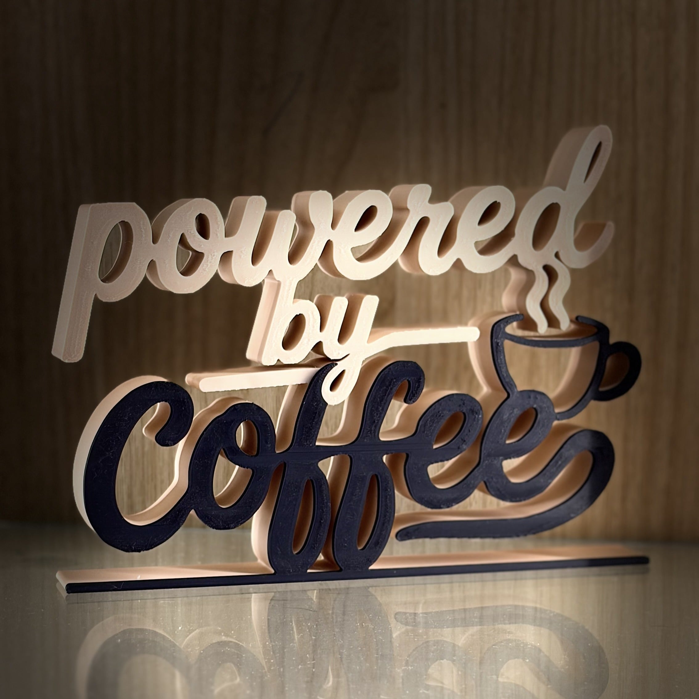 Powered by Coffee 3D printed word art on a wooden background